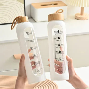 Glass bottle with non-slip protective sleeve and helpful time markers - Plenish